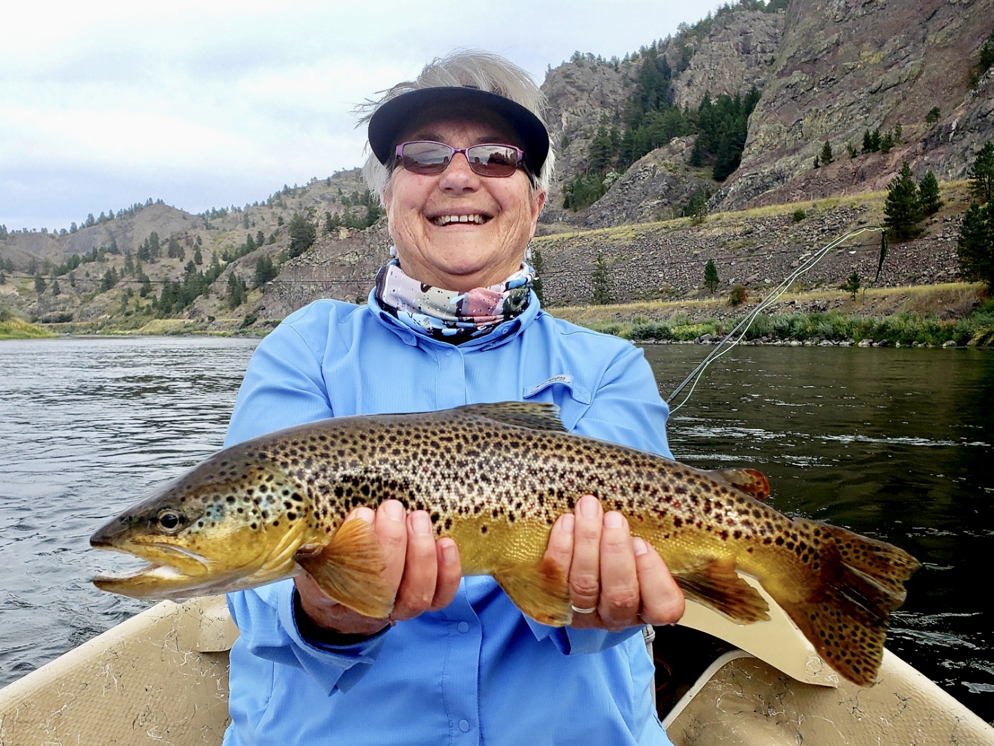 Mom with a big smile and  respectable brown trout on the Missouri River 