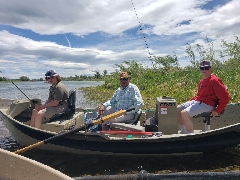 Guide and clients on Missouri River drift boat